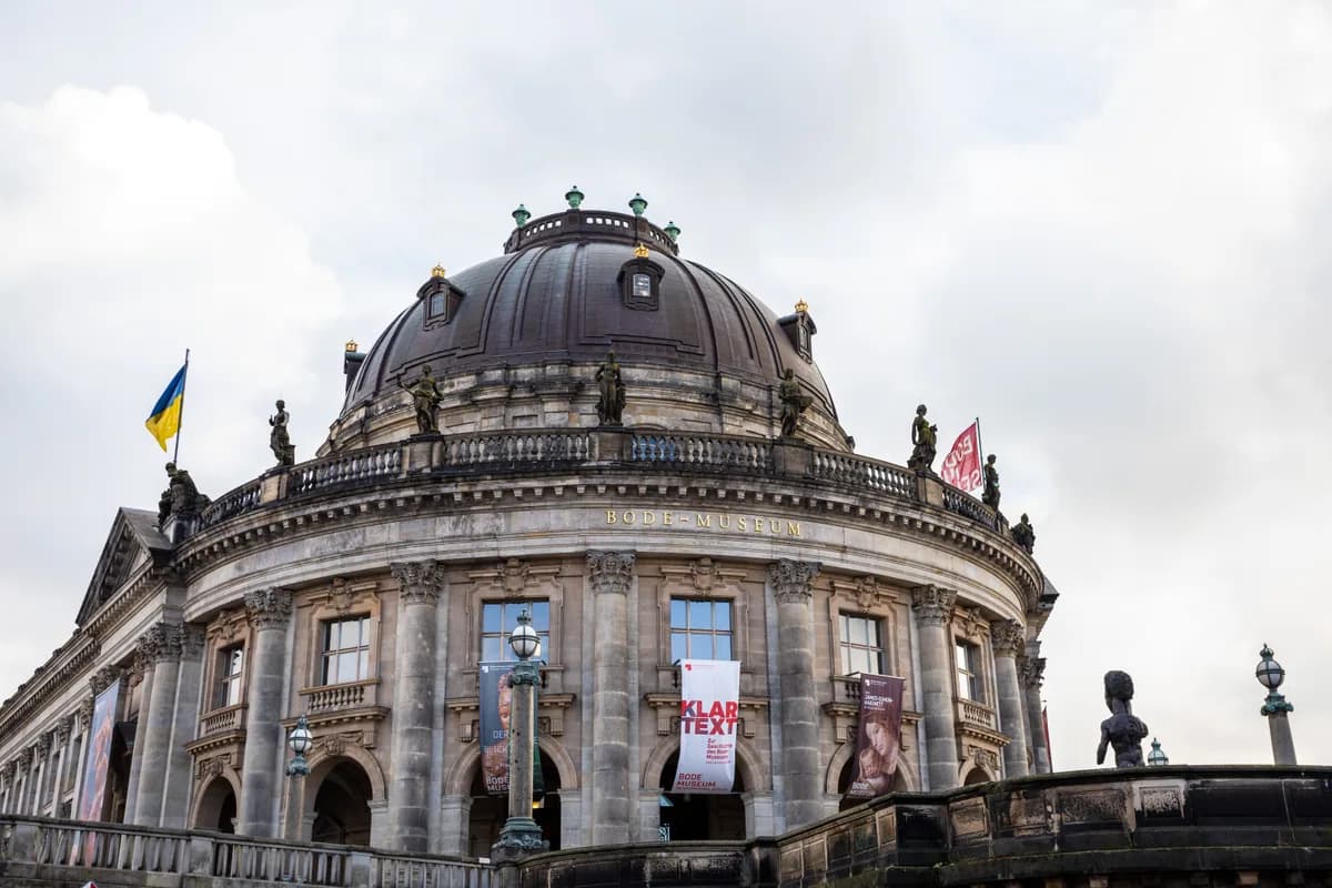 Low angle view of Bode Museum's exterior in Berlin, featuring historic architecture under a cloudy sky.