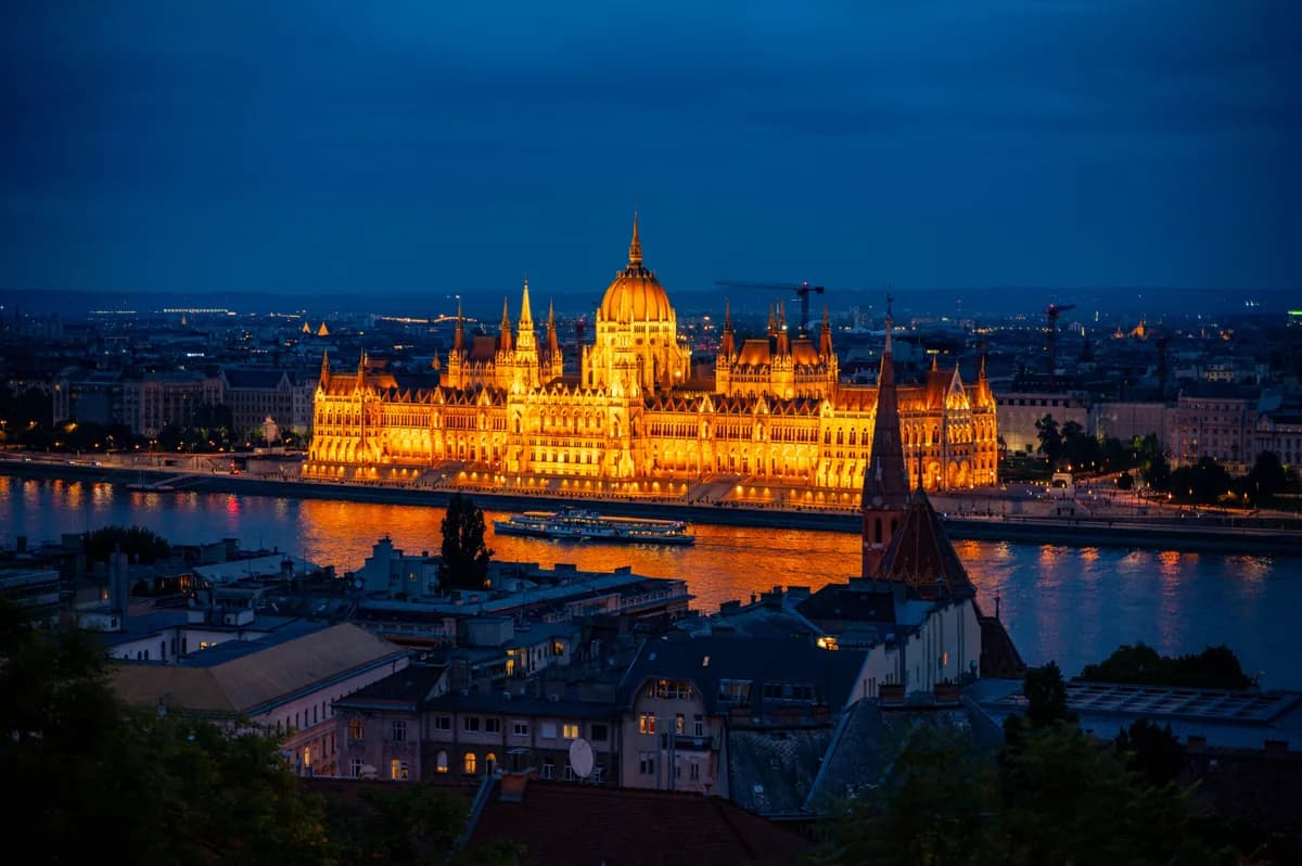 Stunning view of the Hungarian Parliament Building in Budapest glowing under night lights.