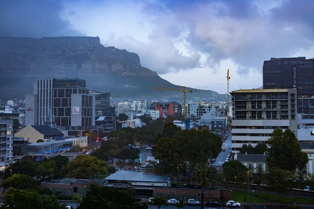 Dusk view of Cape Town cityscape with Table Mountain in the backdrop.