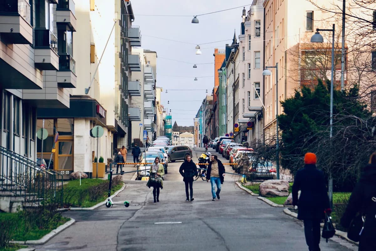 Vibrant street scene in Helsinki, Finland, showcasing pedestrians amidst urban architecture.